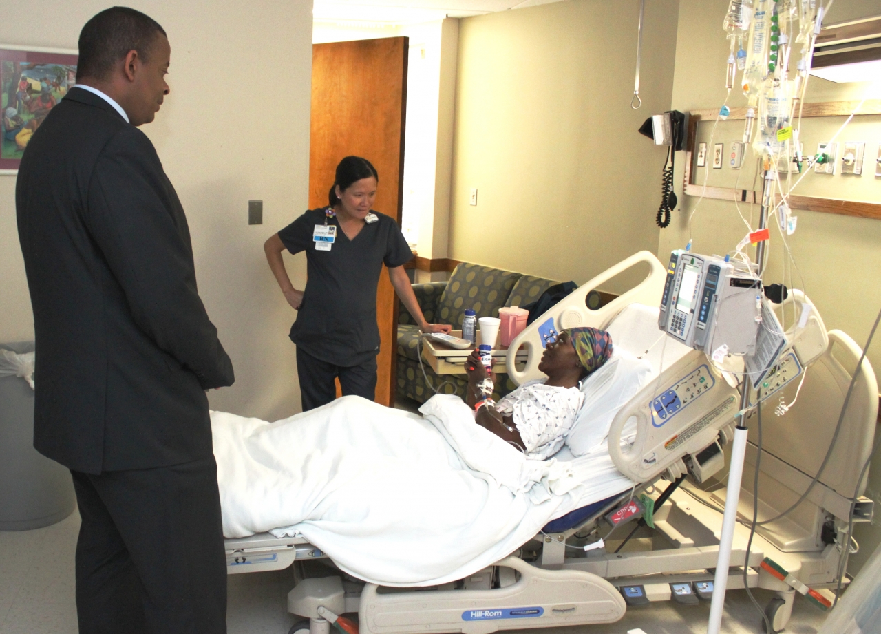 Photo of Secretary Foxx visiting with Martha, a patient