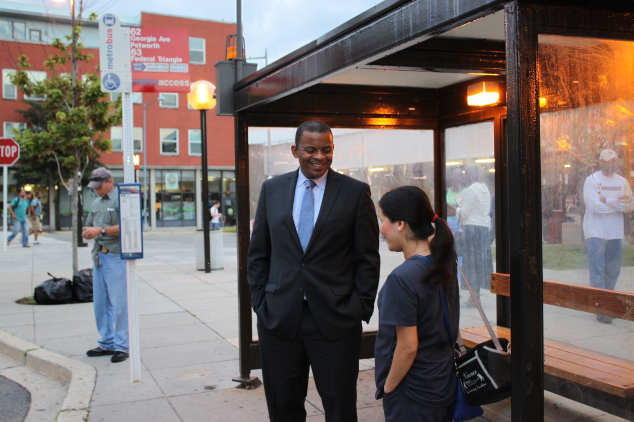 Photo of Lan and Secretary Foxx waiting for the Metrobus 63 at Takoma Station