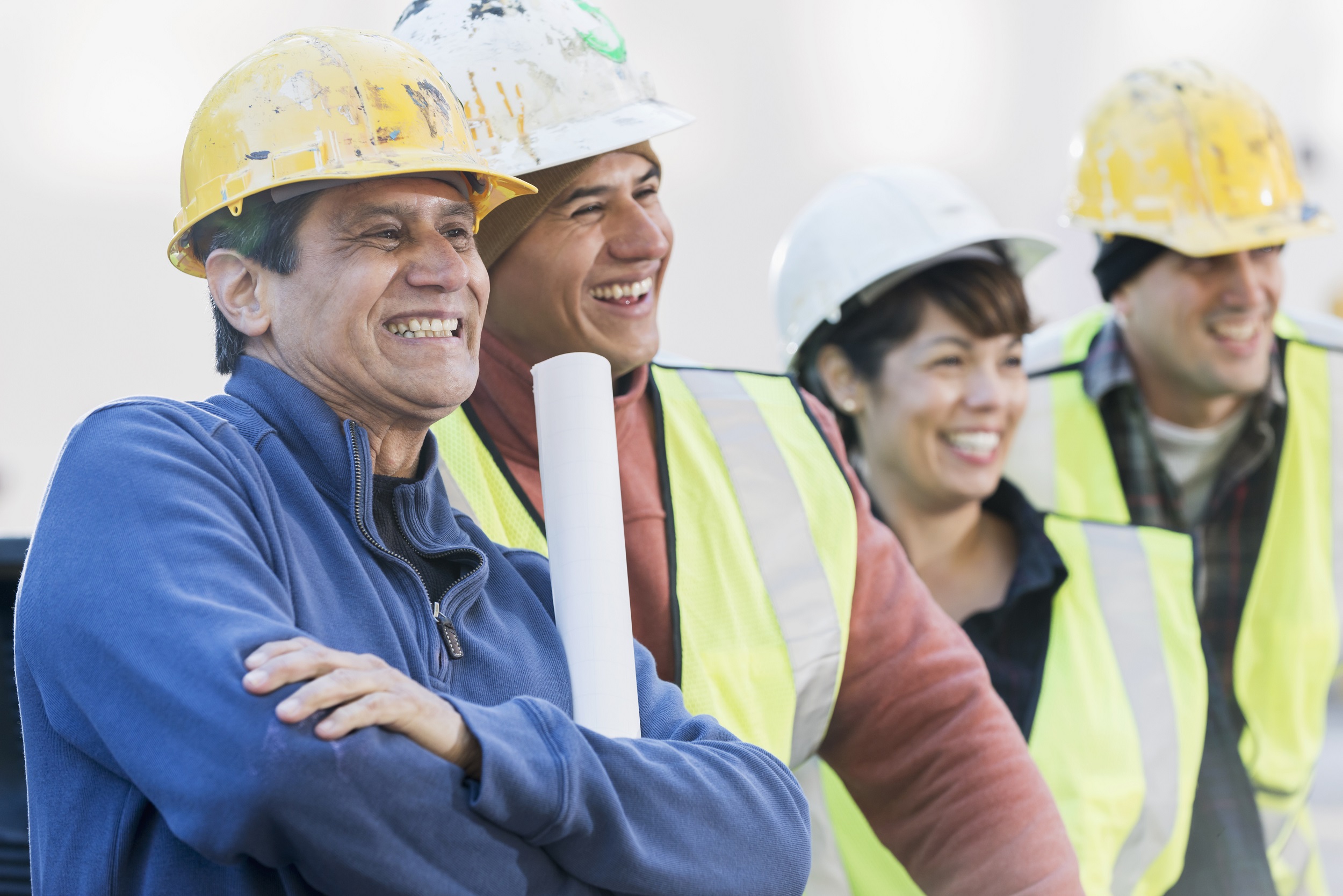 Construction workers look on and laugh.