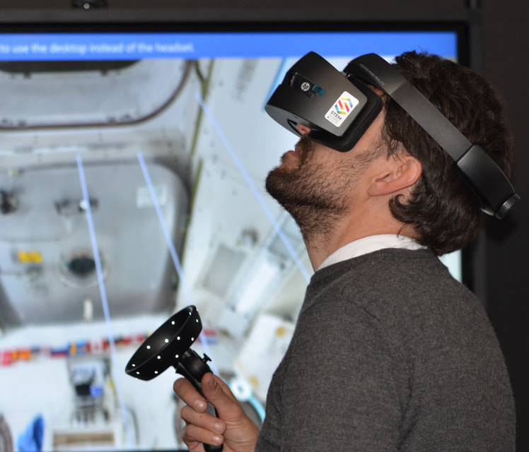 Man is wearing VR device.
