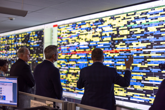 Secretary Duffy in front of a FedEx logistic screen