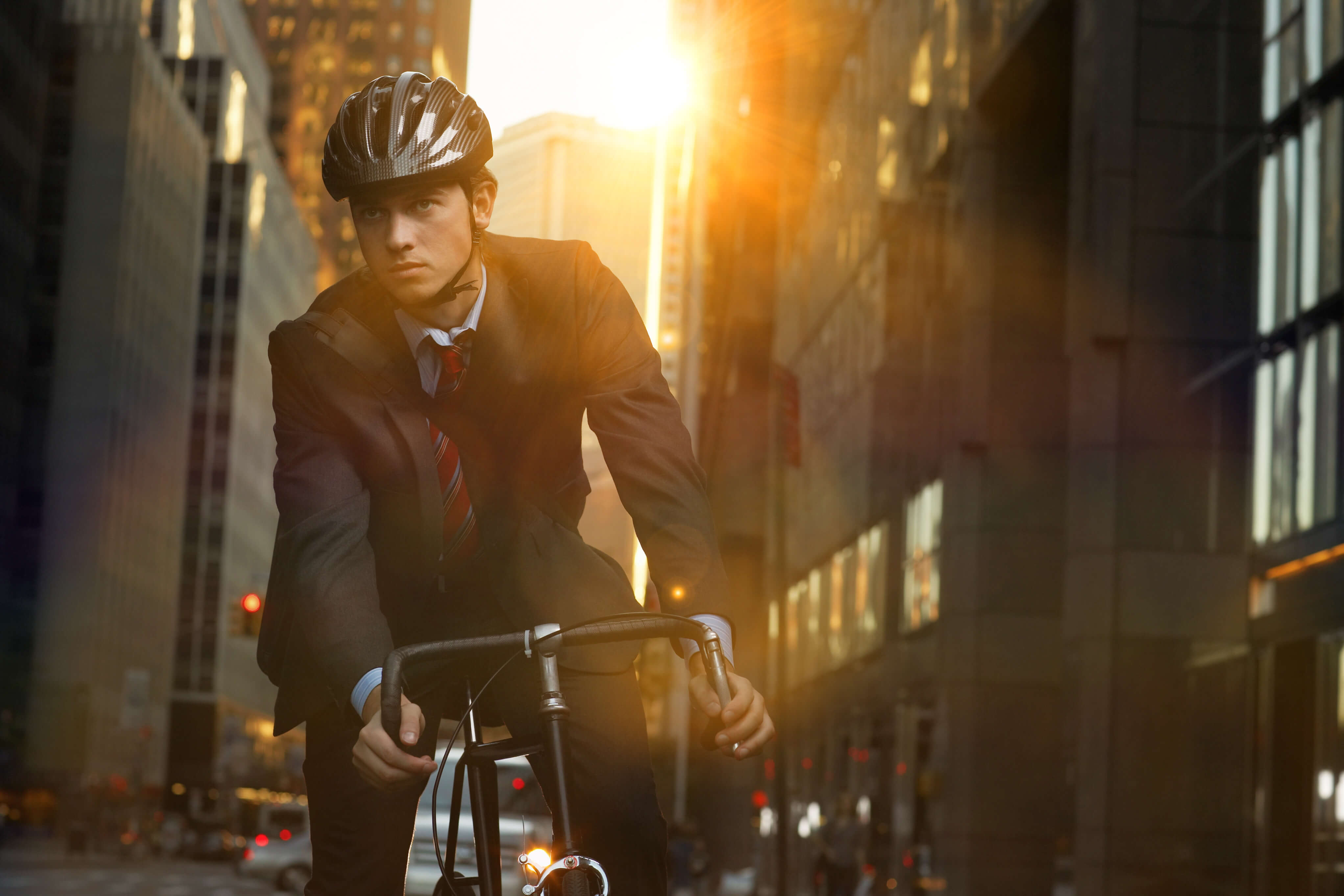 A man wearing a helmet rides his bike.