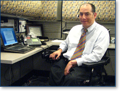 man in wheelchair at desk