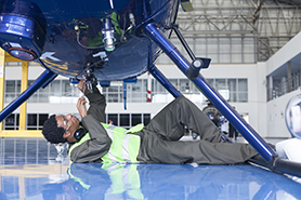 Image of a mechanic working on a helicopter