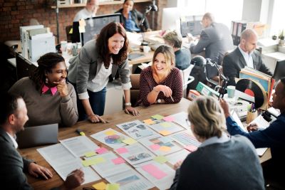 Group of people sitting around a table with planning materials.