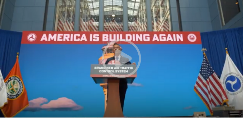 "America is buildling again" Secretary Duffy giving remarks behind a podium at USDOT HQ