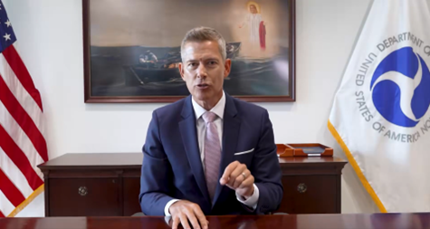 Secretary Duffy sitting in front of desk with Christ on the Water painting in the background