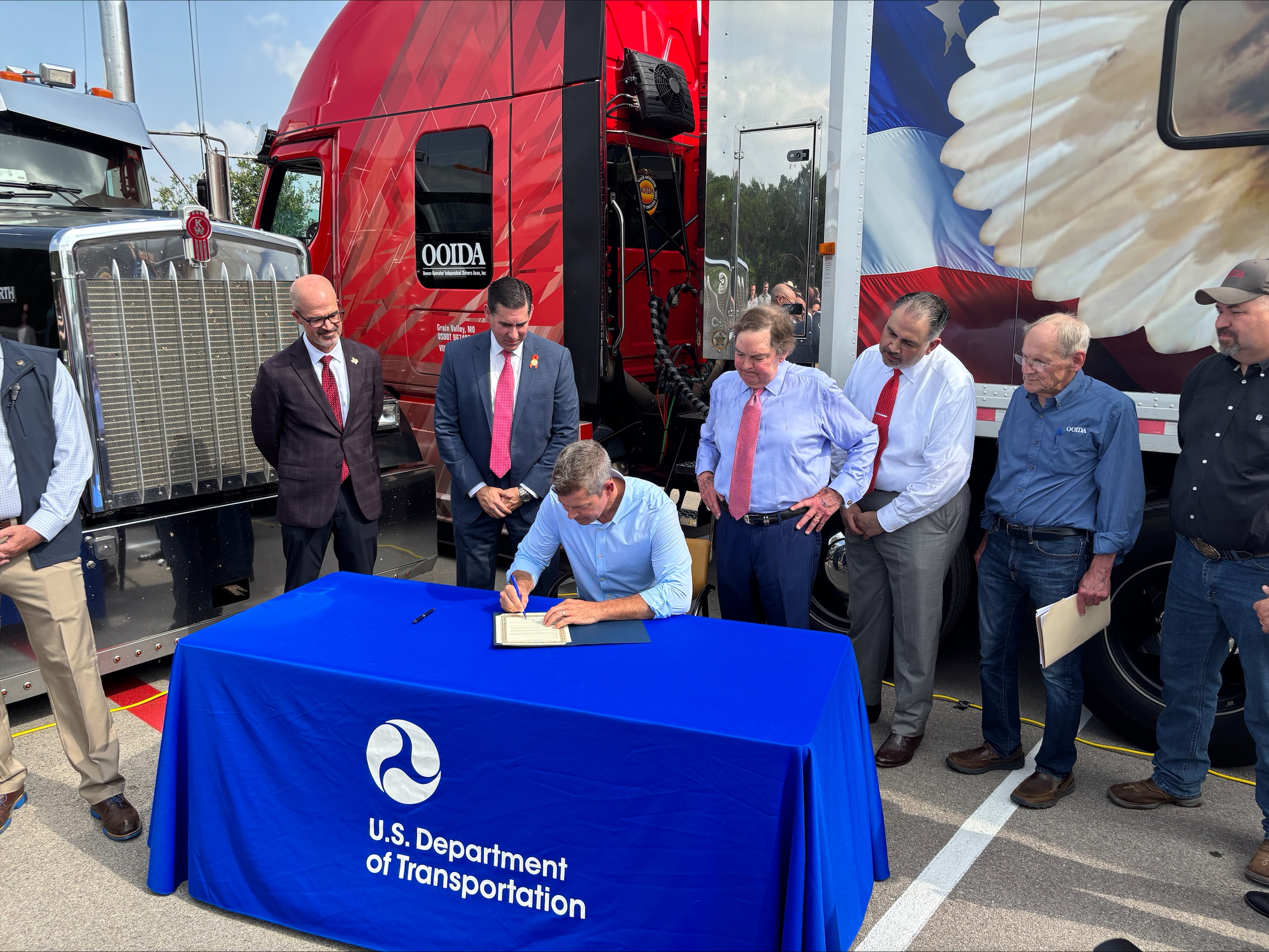 Secretary Duffy signing executive order on new guidance to enforce English proficiency requirement for truckers