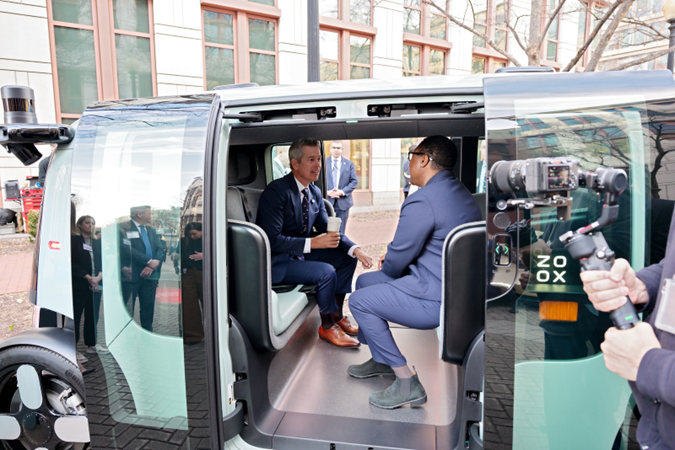 Secretary Duffy in Zoox vehicle at the Innovation Plaza