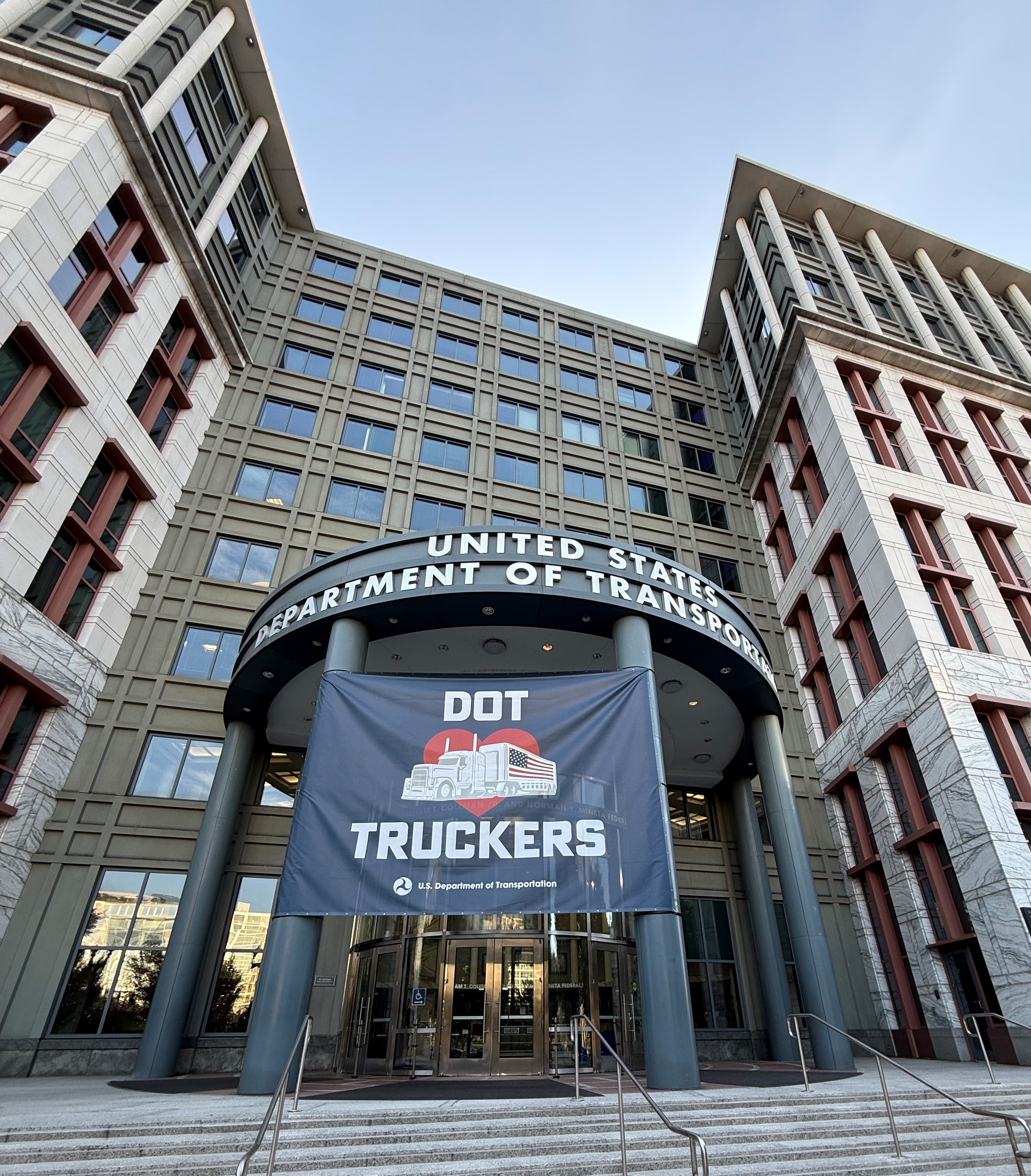 Front of USDOT building with DOT Truckers flag in front