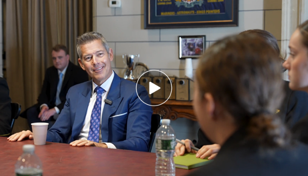 Secretary Duffy sitting with midshipmen