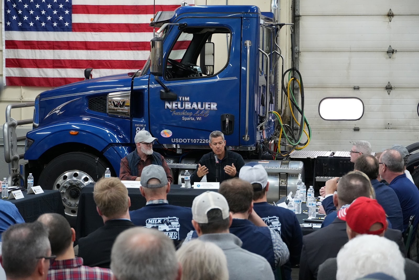 Secretary Duffy and U.S. Congressman Van Orden (WI-03) at roundtable with truck behind them