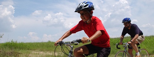 kids on bikes by a beach