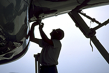 Aviation mechanic working on plane