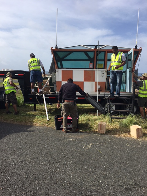 Men setting up mobile air traffic control tower
