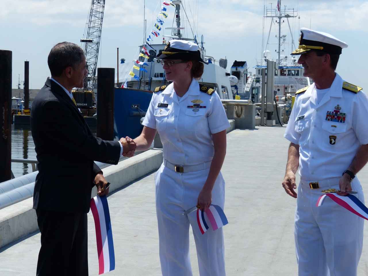 Photo of Victor Mendez with Midshipman Erin Hofstetter, First Class and Rear Admiral James Helis.