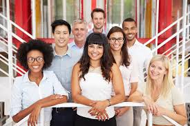 A diverse group photo of interns in office environment.