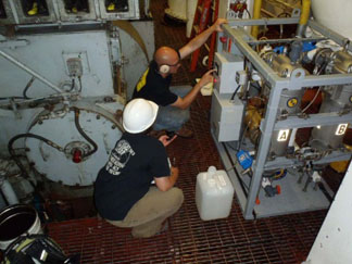 Two engineers working on machine