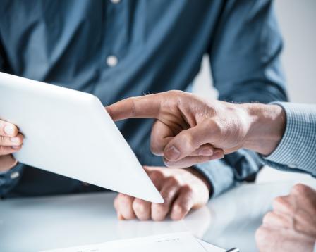 finger pointing a tablet