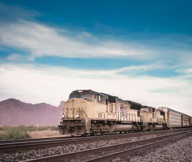 A train with a mountain backdrop.