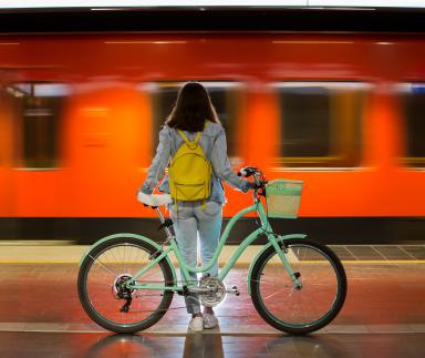 girl with bike waiting for train