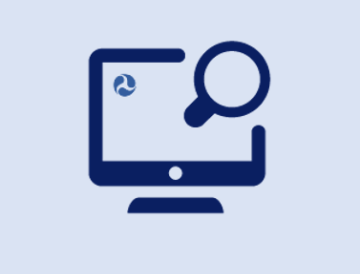 A computer screen with a Department of Transportation logo and an internet search magnifying glass.