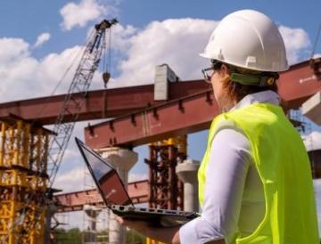 Person looking up at bridge construction