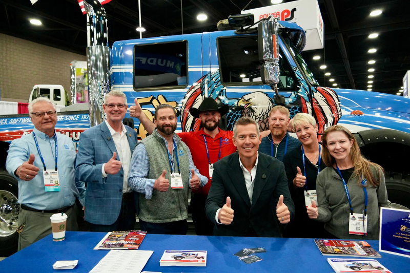 Secretary Duffy and FMCSA Administrator Barrs photo in front of truck with Allen Lund Company team