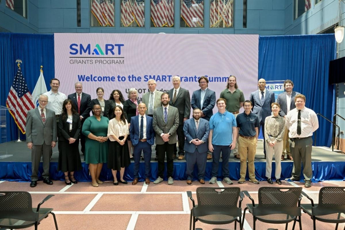 U.S. DOT employees supporting the event pose for a photo during the 2026 SMART Summit.